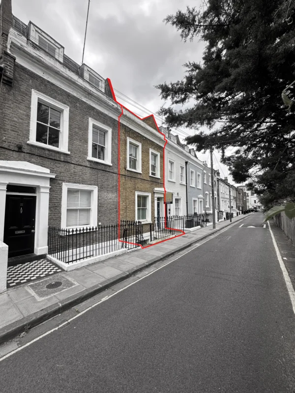 A terraced house with striking architecture is highlighted in red on a quiet street; the rest of the image is in black and white except for the outlined house, showcasing design expertise by Plus Architects.